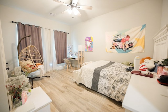 bedroom with ceiling fan and wood-type flooring