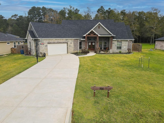 craftsman house with a garage and a front lawn