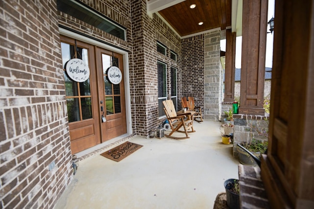 property entrance with a porch and french doors