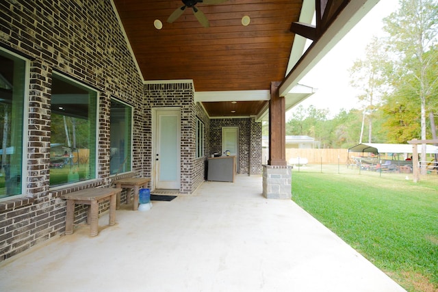 view of patio / terrace with a carport and ceiling fan