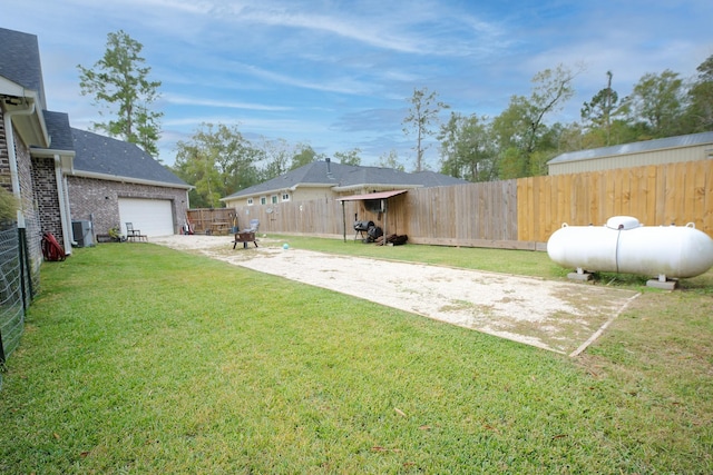 view of yard with cooling unit and a garage