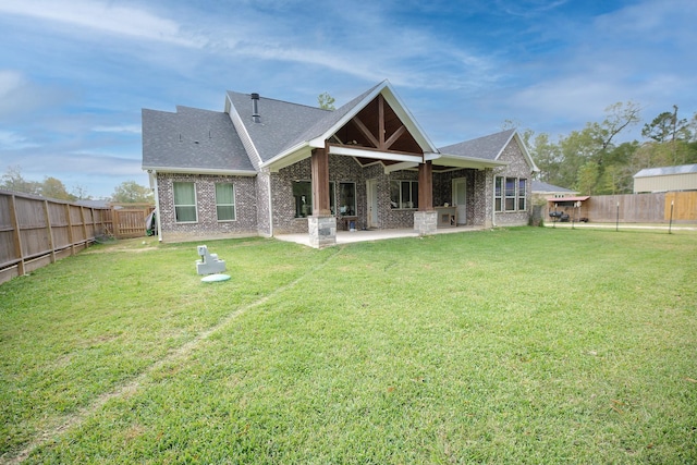 back of property with a lawn and a patio