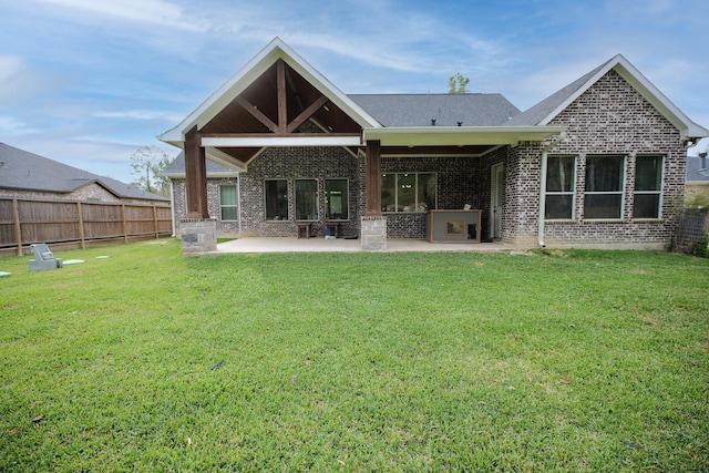 back of property with a lawn and a patio