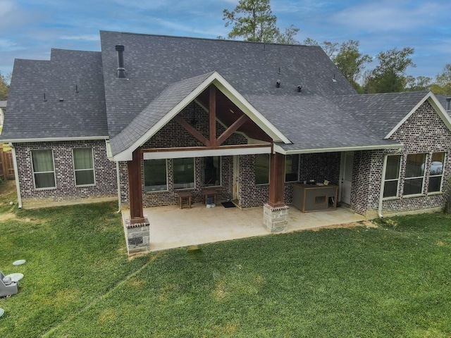 rear view of house featuring a yard, area for grilling, and a patio area