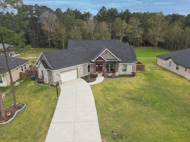 craftsman inspired home featuring a front lawn and a garage