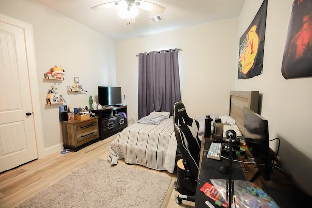 bedroom with ceiling fan and hardwood / wood-style floors