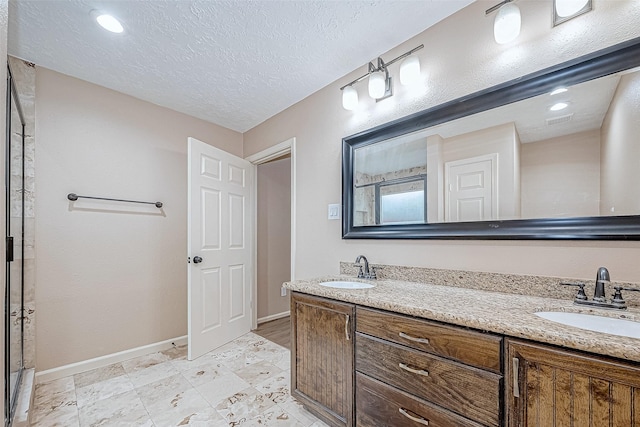 bathroom featuring vanity, a textured ceiling, and walk in shower