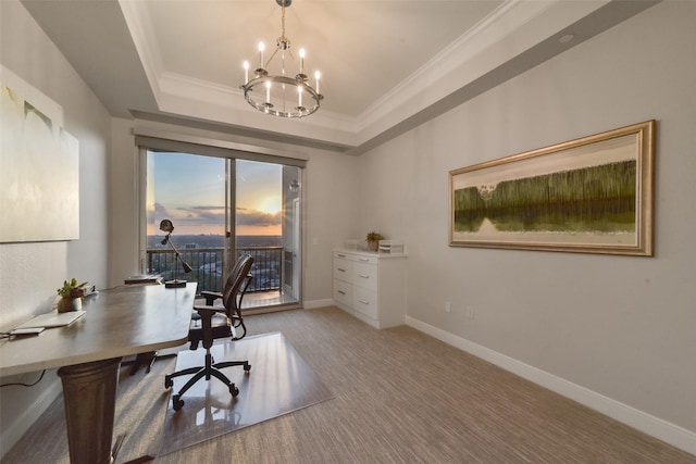 office area with an inviting chandelier, crown molding, and a tray ceiling