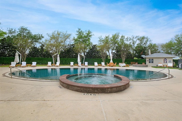 view of swimming pool with a patio area and an in ground hot tub