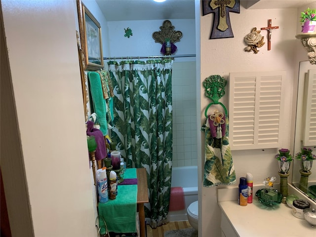 full bathroom featuring toilet, hardwood / wood-style floors, vanity, and shower / tub combo with curtain