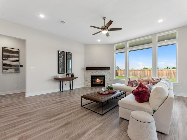 living room featuring ceiling fan and light hardwood / wood-style floors