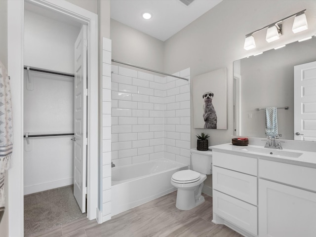 full bathroom with toilet, vanity, and tiled shower / bath combo