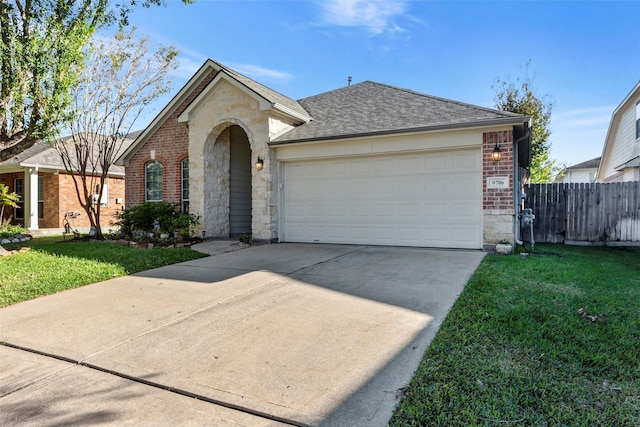 single story home featuring a garage and a front lawn