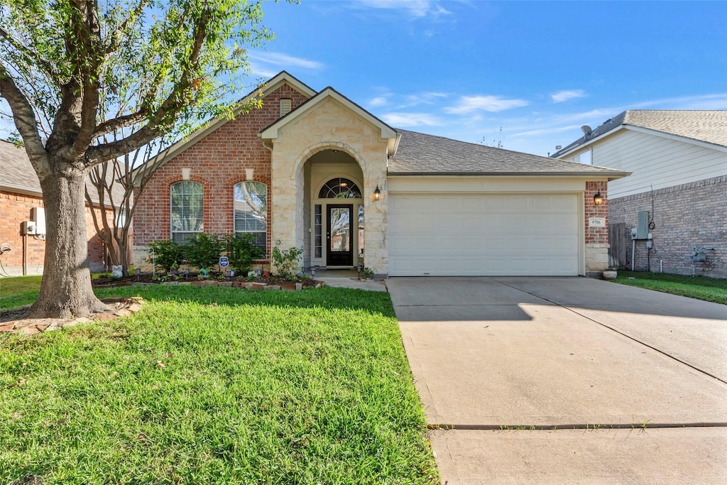 ranch-style house with a front yard and a garage