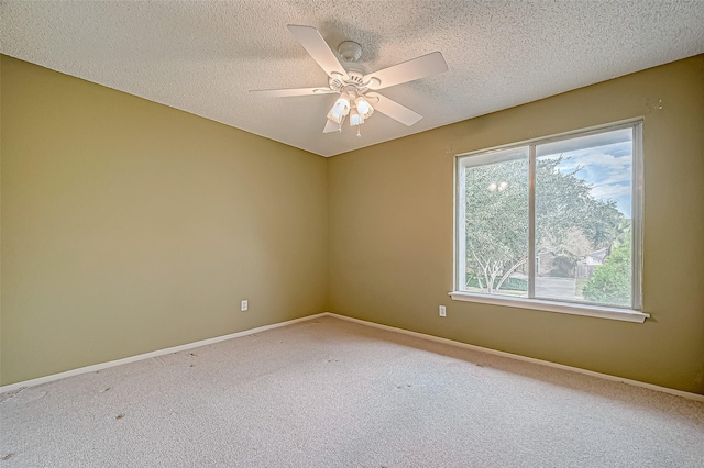 carpeted spare room with ceiling fan and a textured ceiling