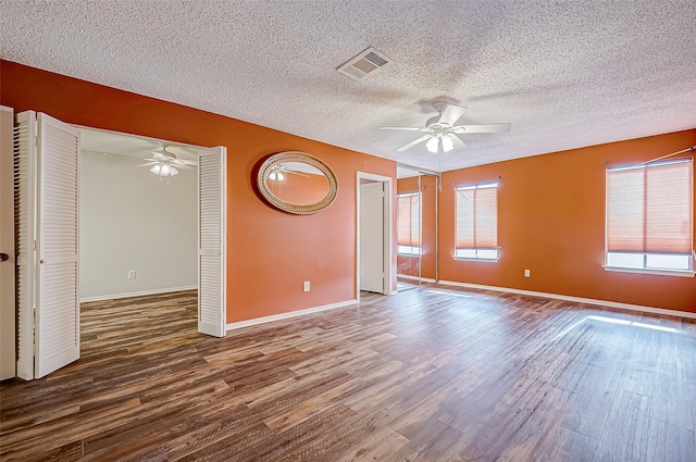 unfurnished room featuring a textured ceiling, hardwood / wood-style flooring, and ceiling fan