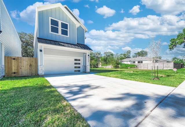 view of front of home with a front yard and a garage