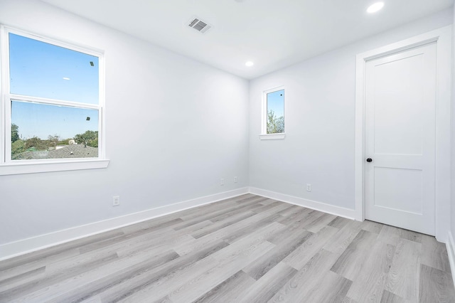 spare room with light hardwood / wood-style floors