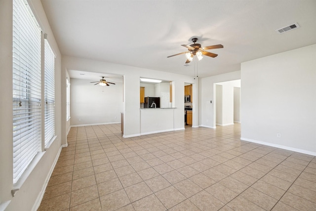 unfurnished living room with light tile patterned floors and ceiling fan