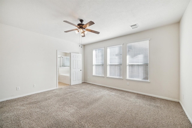 carpeted spare room with ceiling fan