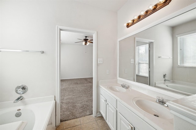 bathroom with tile patterned floors, ceiling fan, a healthy amount of sunlight, and a tub