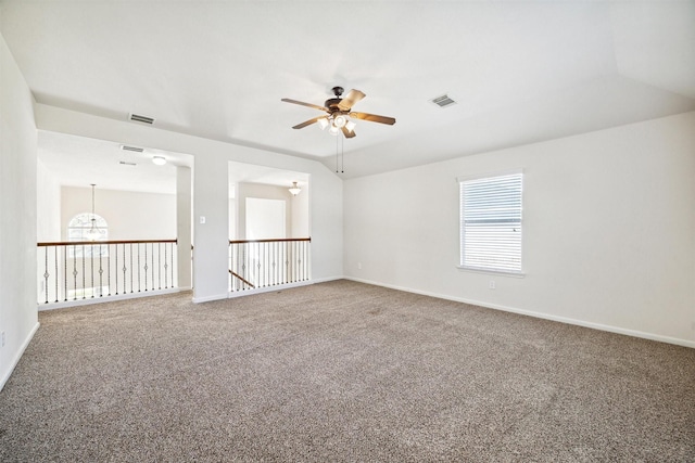 unfurnished room featuring carpet flooring and ceiling fan with notable chandelier