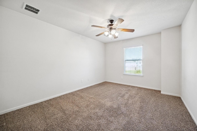 carpeted spare room with ceiling fan