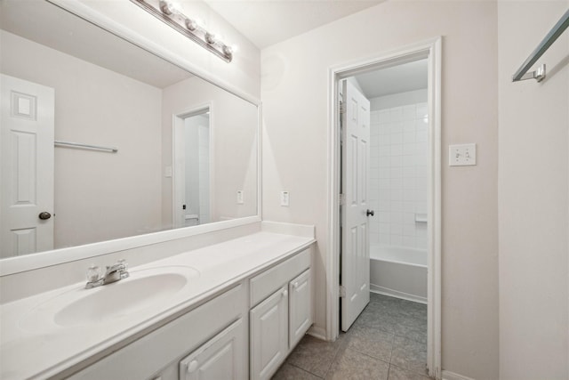 bathroom featuring tile patterned floors, vanity, and tiled shower / bath combo