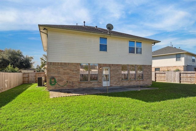 rear view of house featuring a yard and a patio