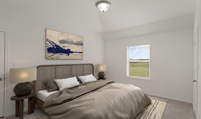 bedroom with light carpet and lofted ceiling