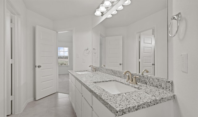 bathroom featuring tile patterned flooring and vanity