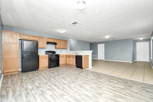 kitchen featuring light wood-type flooring, a textured ceiling, sink, black appliances, and light brown cabinets