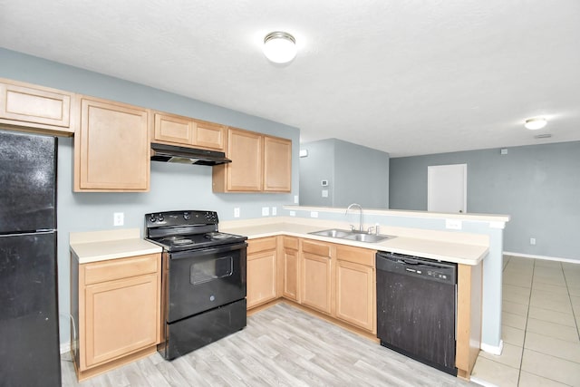 kitchen with light wood-type flooring, light brown cabinets, sink, and black appliances