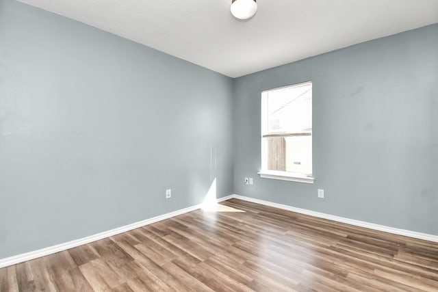 unfurnished room featuring hardwood / wood-style flooring