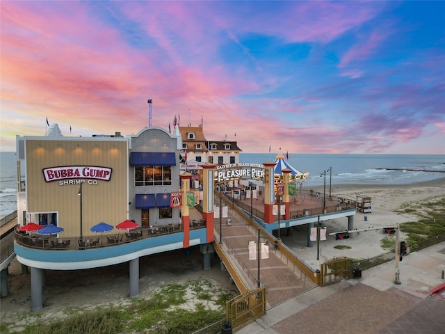 dock area featuring a water view and a beach view