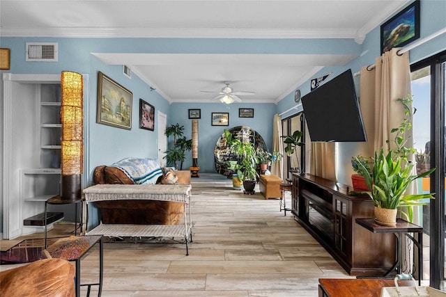 living room featuring ceiling fan, crown molding, and light hardwood / wood-style flooring