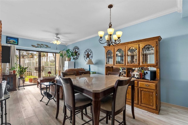 dining room featuring light wood-type flooring, ceiling fan with notable chandelier, and ornamental molding