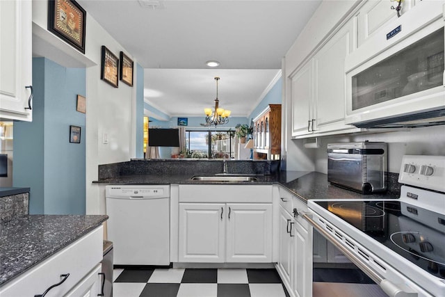 kitchen with white cabinets, white appliances, sink, and a chandelier