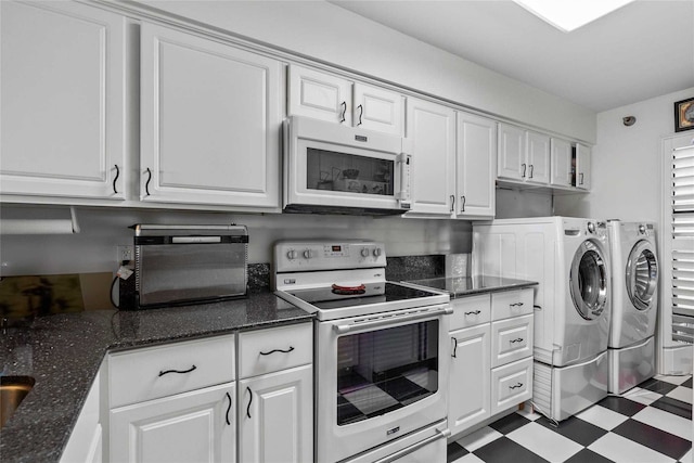 kitchen featuring white cabinets, white appliances, separate washer and dryer, and dark stone counters