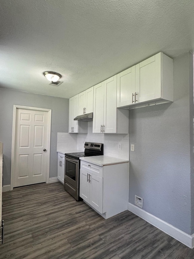 kitchen with white cabinetry, electric range, dark wood-type flooring, and a textured ceiling