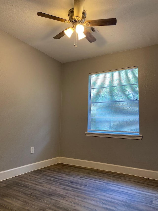 unfurnished room featuring ceiling fan and dark hardwood / wood-style flooring