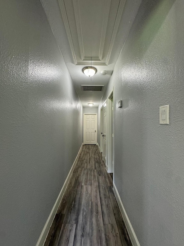 hallway with crown molding and dark hardwood / wood-style floors