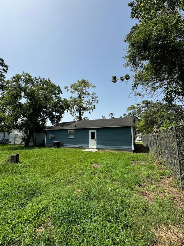 rear view of house featuring a lawn