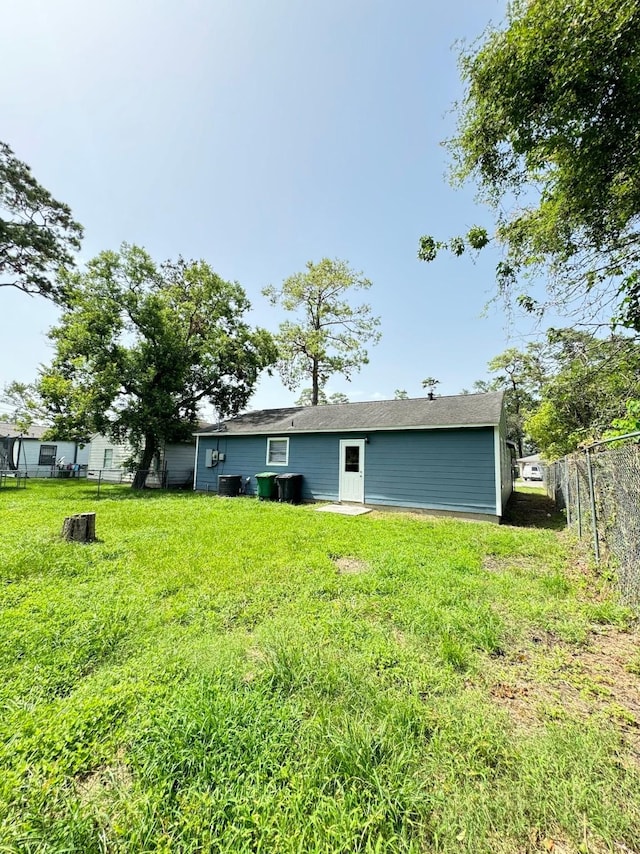 rear view of property with a yard