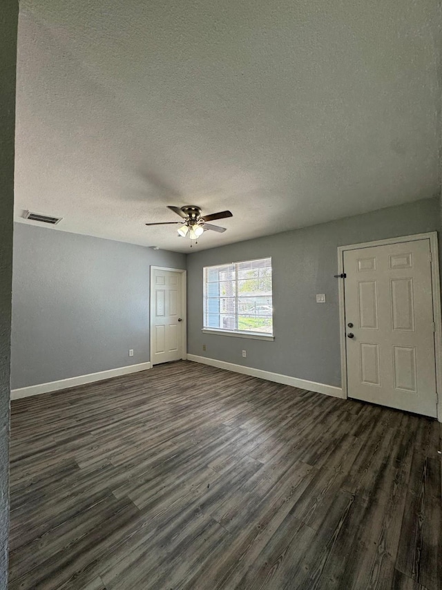 interior space featuring a textured ceiling, dark hardwood / wood-style floors, and ceiling fan