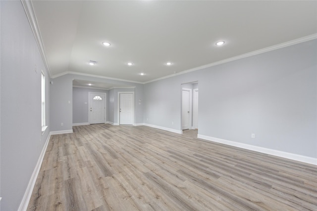 unfurnished living room featuring light hardwood / wood-style flooring, lofted ceiling, and ornamental molding