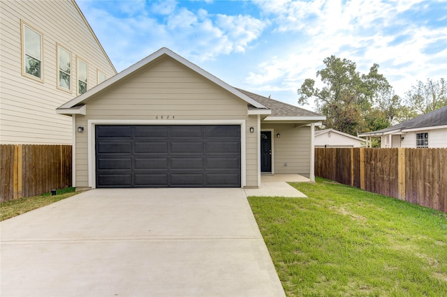 view of front of house featuring a front lawn and a garage