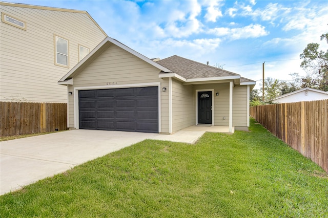 view of front of property with a garage and a front lawn