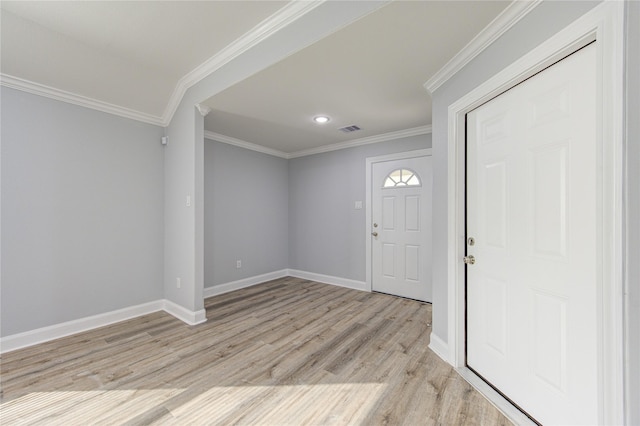 entrance foyer featuring ornamental molding and light wood-type flooring