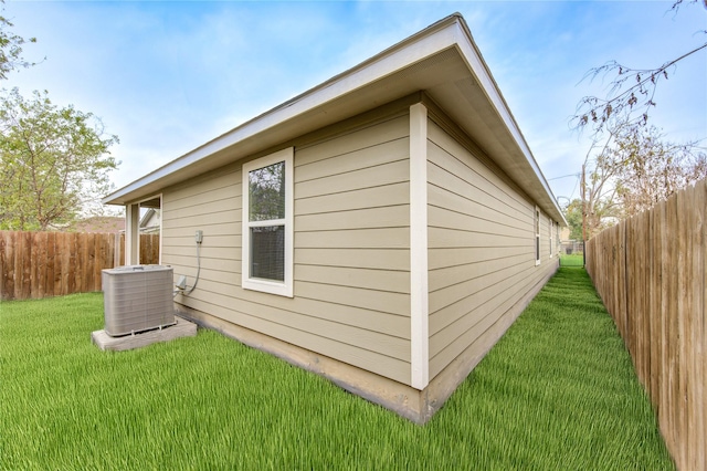 view of property exterior with a lawn and central AC